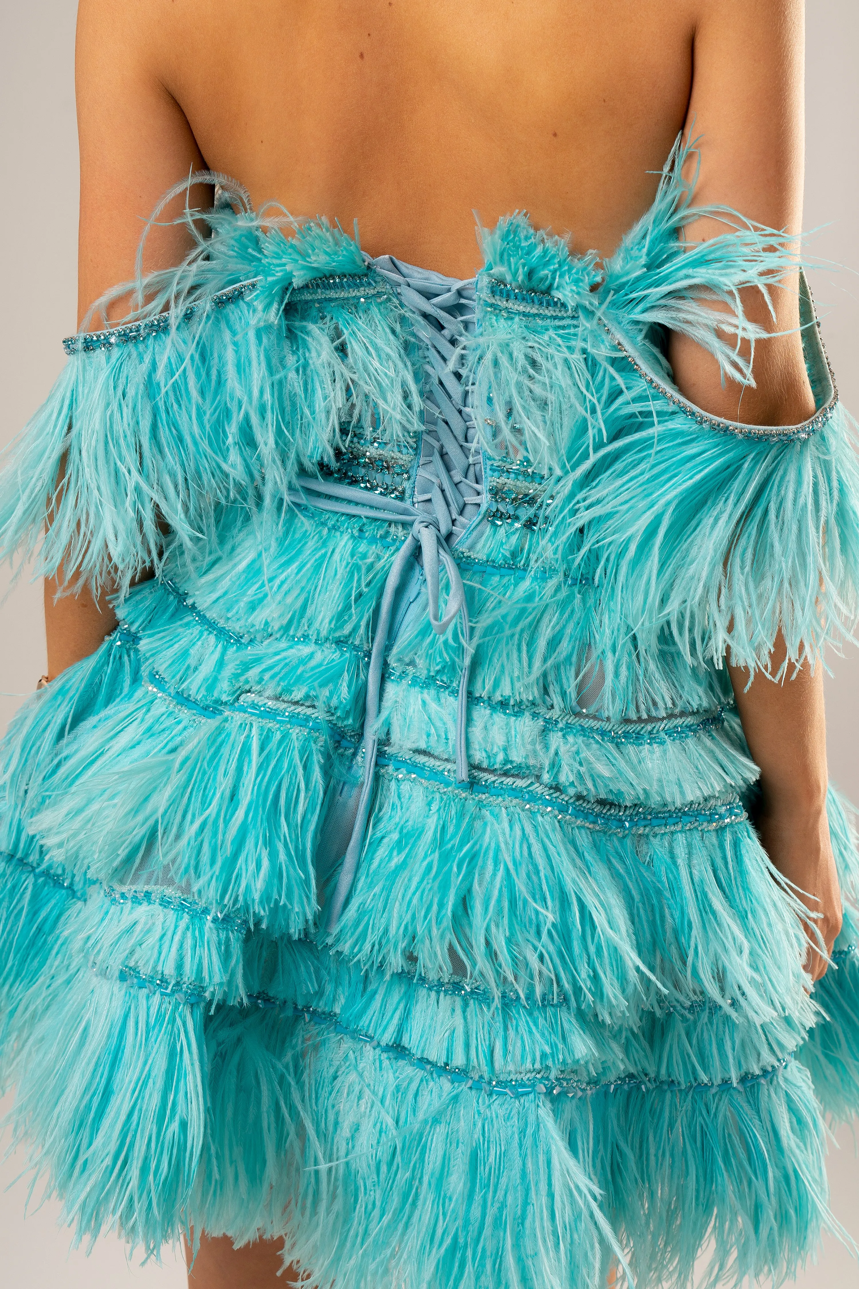 Bright blue feathering off the shoulder and short layered skirt dress