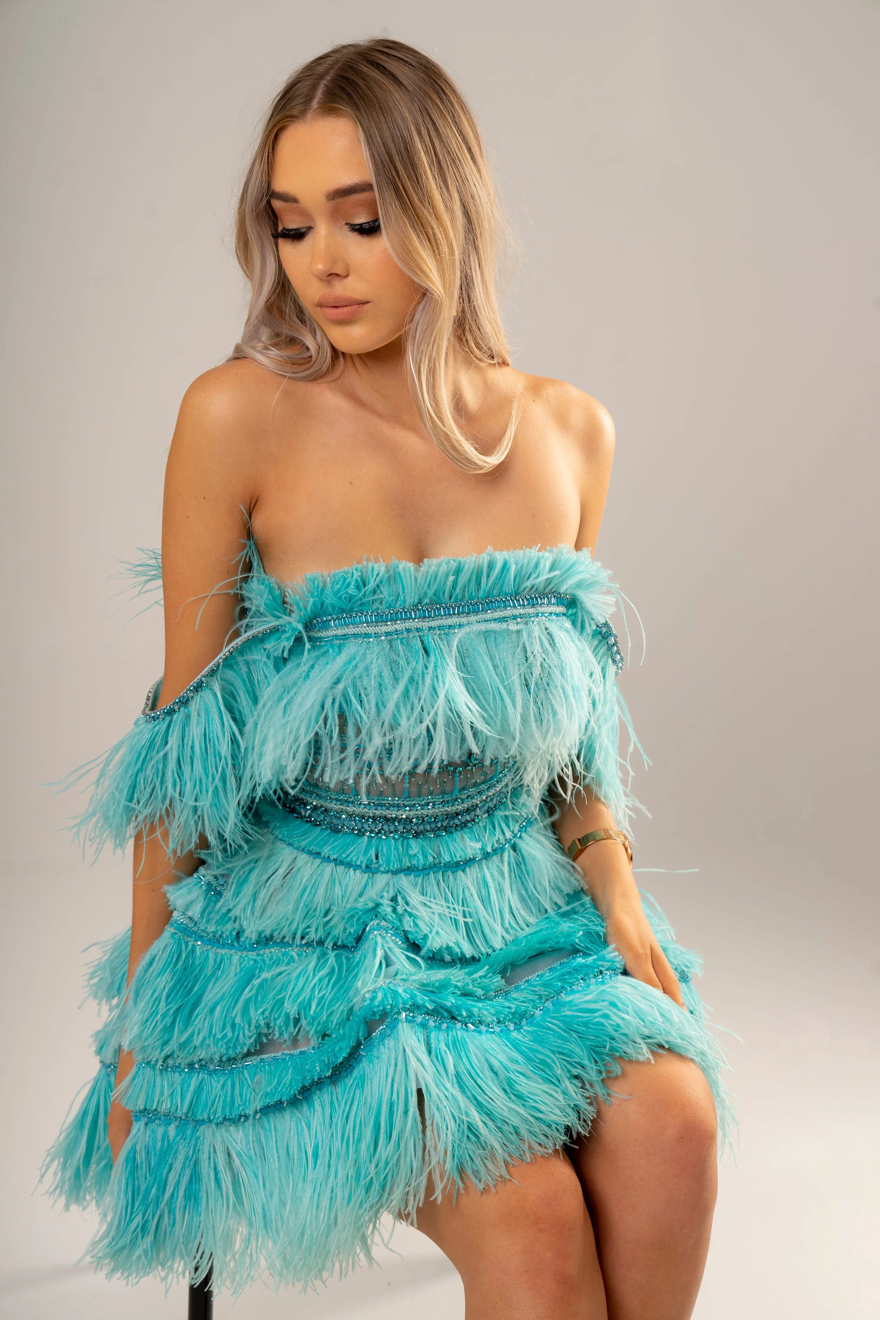 Bright blue feathering off the shoulder and short layered skirt dress