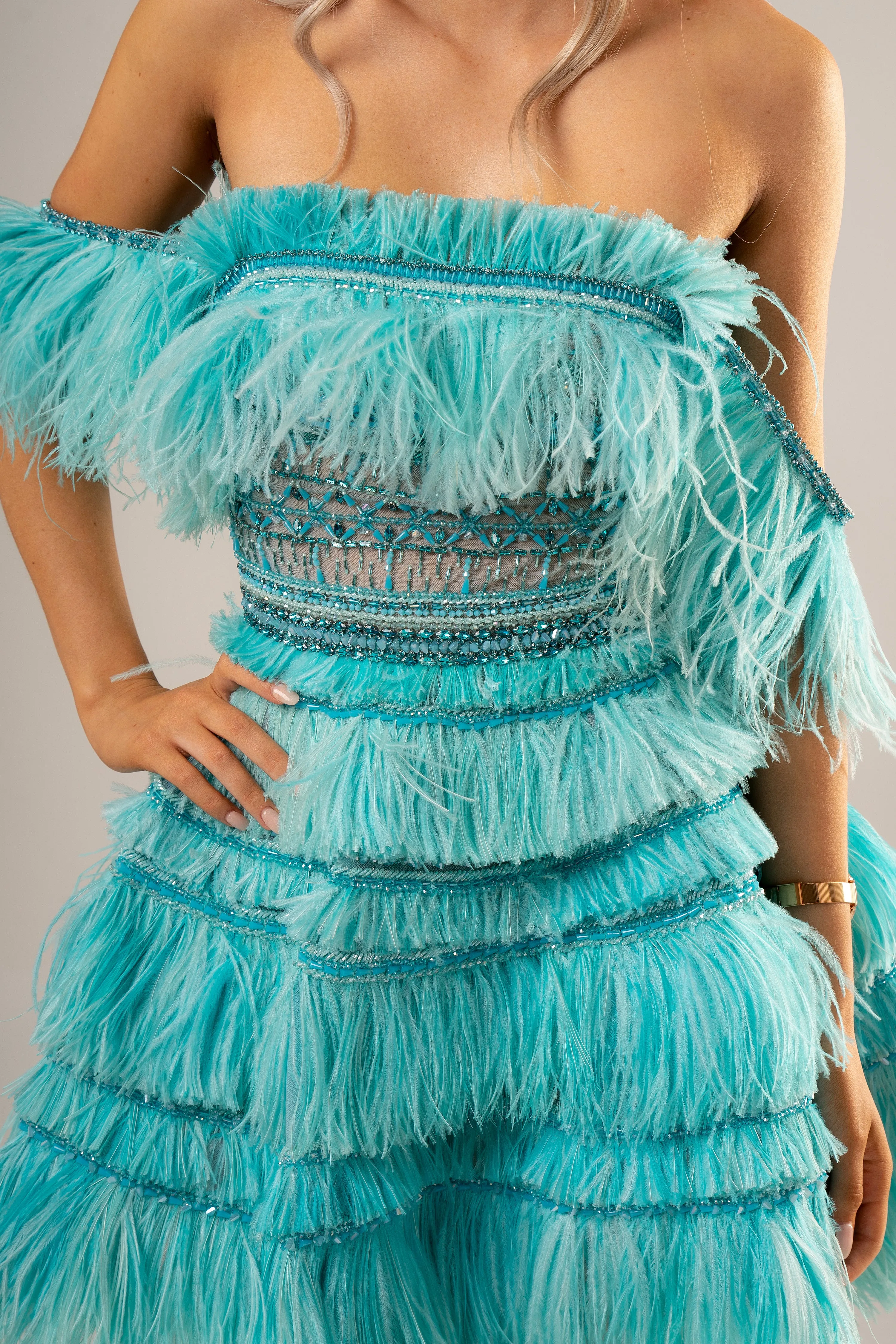 Bright blue feathering off the shoulder and short layered skirt dress